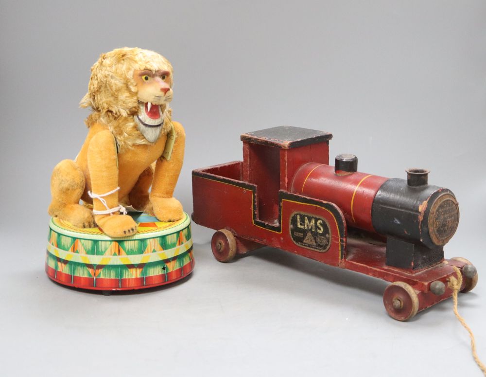 A 1950s-60s Rock Vally Toy battery operated circus lion together with a pull along wooden locomotive